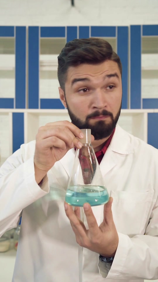 A man in the laboratory tries to identify the smell of a chemical in a