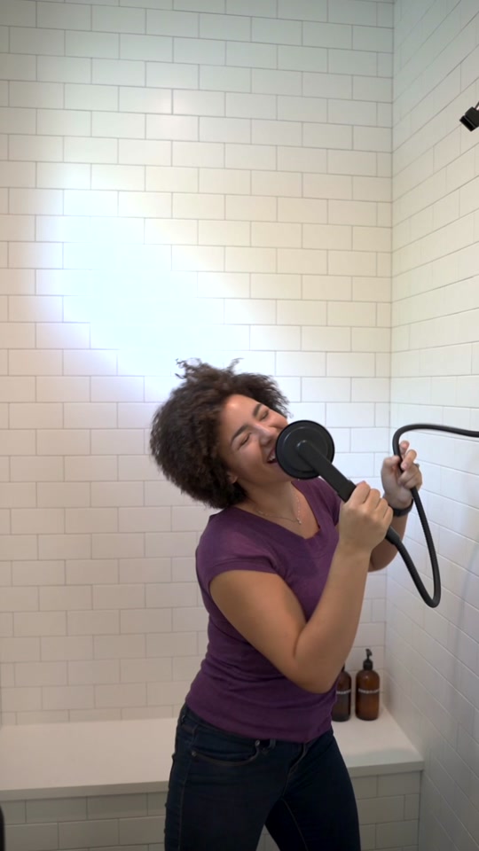 An excited girl having fun singing in the bathroom Stock Gif 1000789